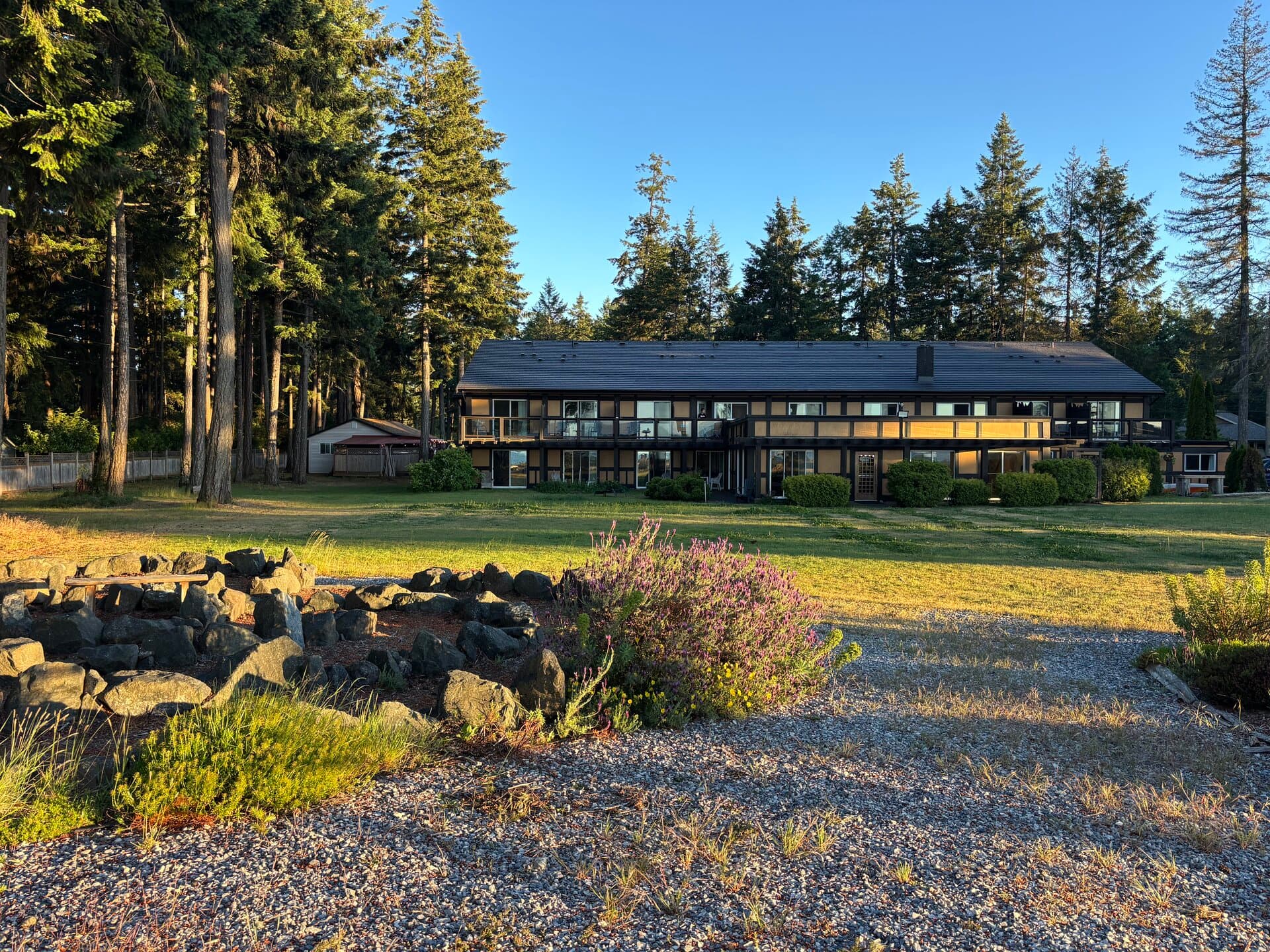 Main lodge at golden hour with expansive lawn