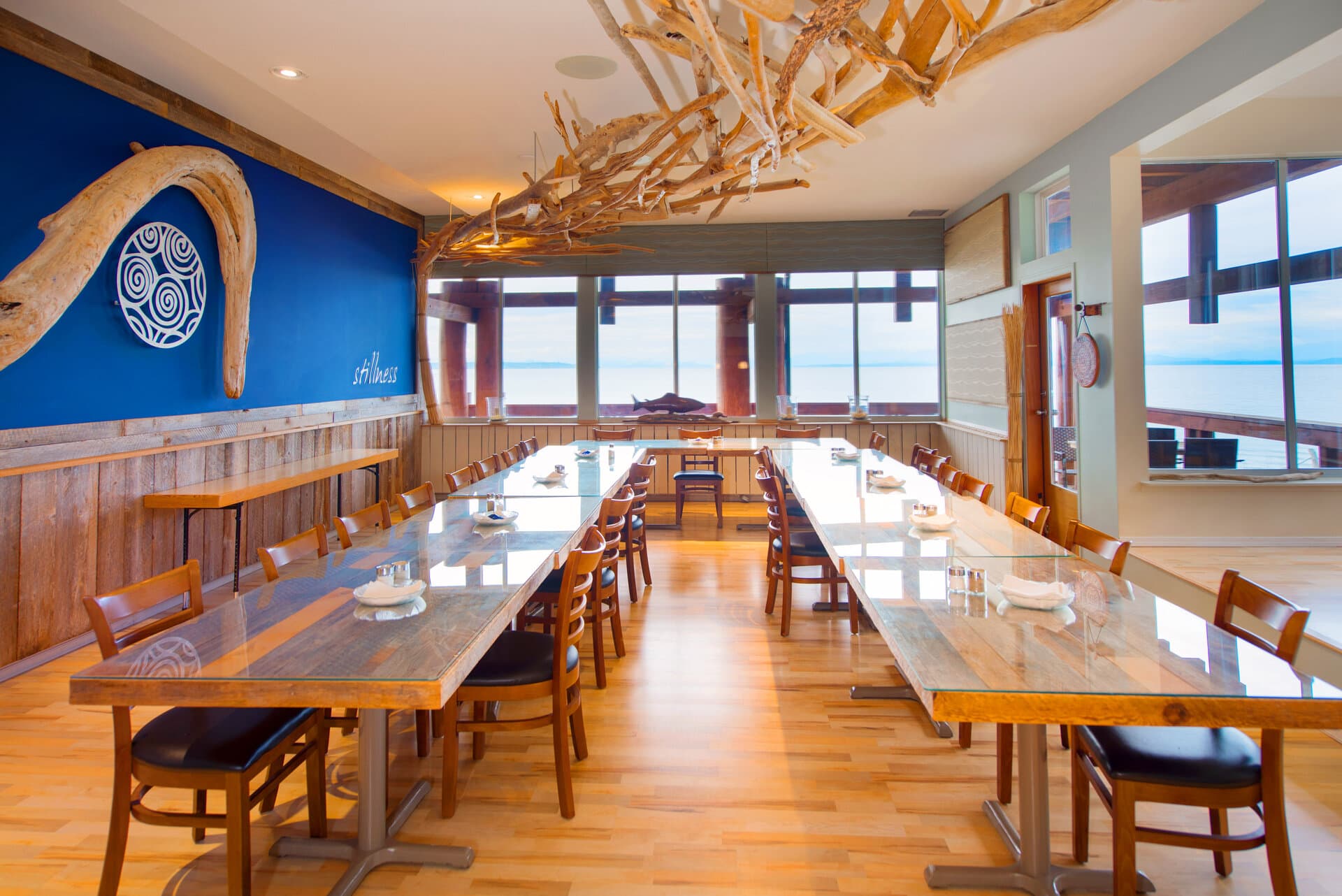 Conference and dining space with long tables and panoramic ocean views