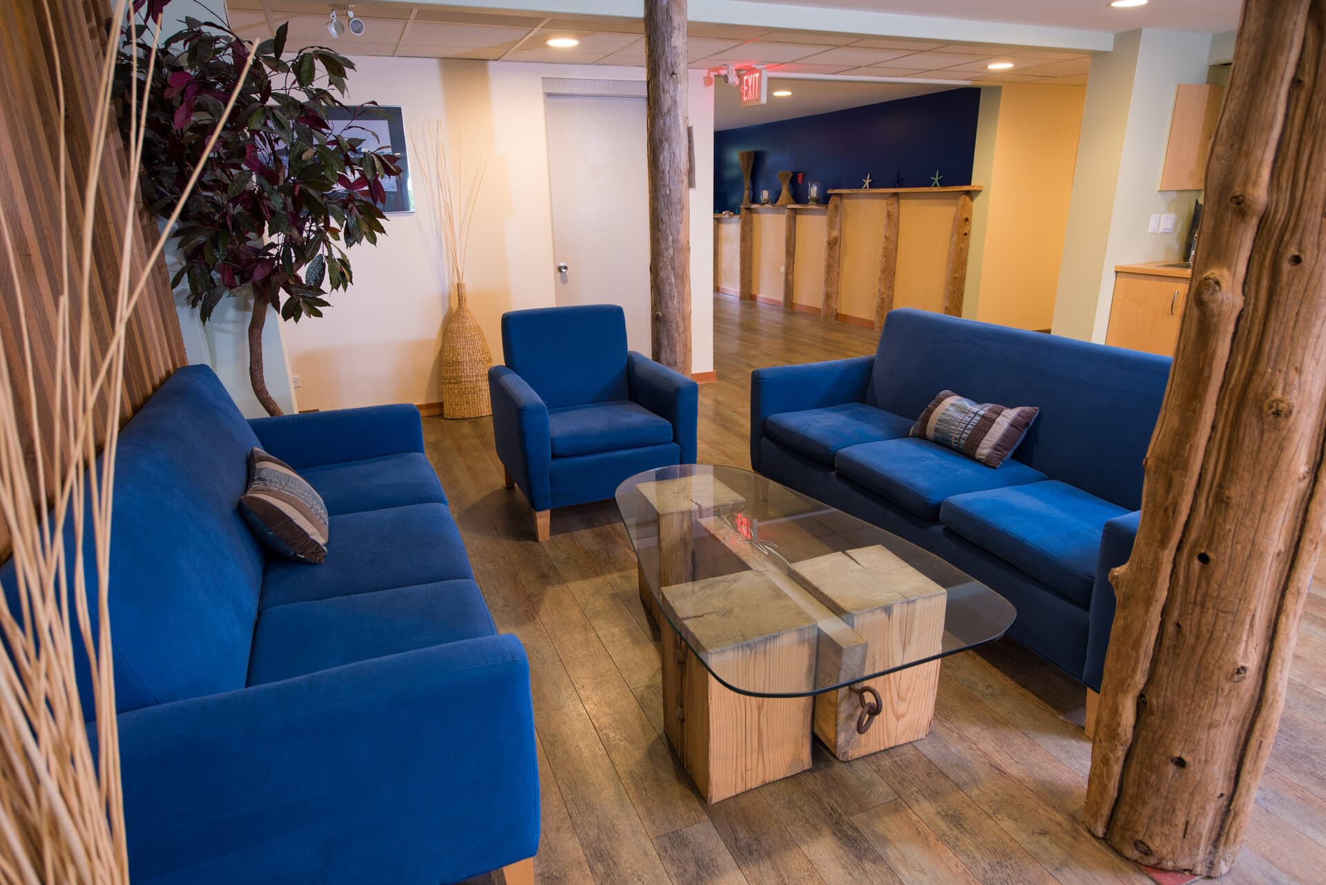 Welcoming lounge area with blue seating and natural wood details