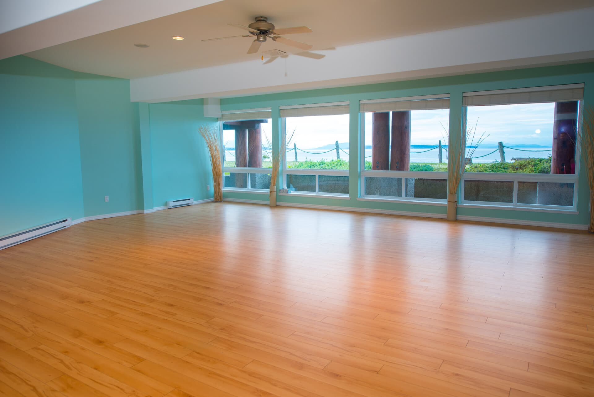 Bright multipurpose event room with wood flooring and ocean views