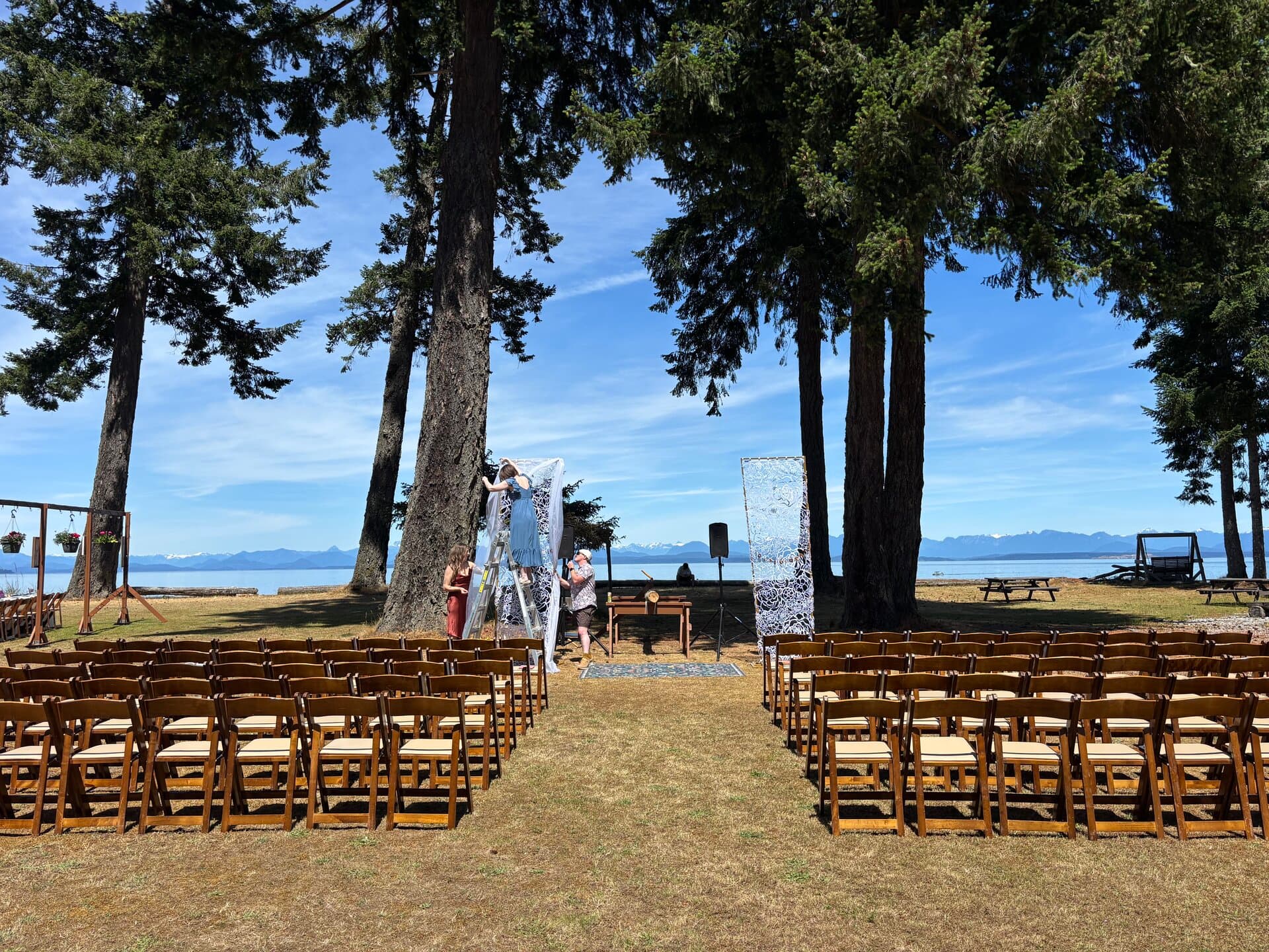 Wedding ceremony under trees with ocean views