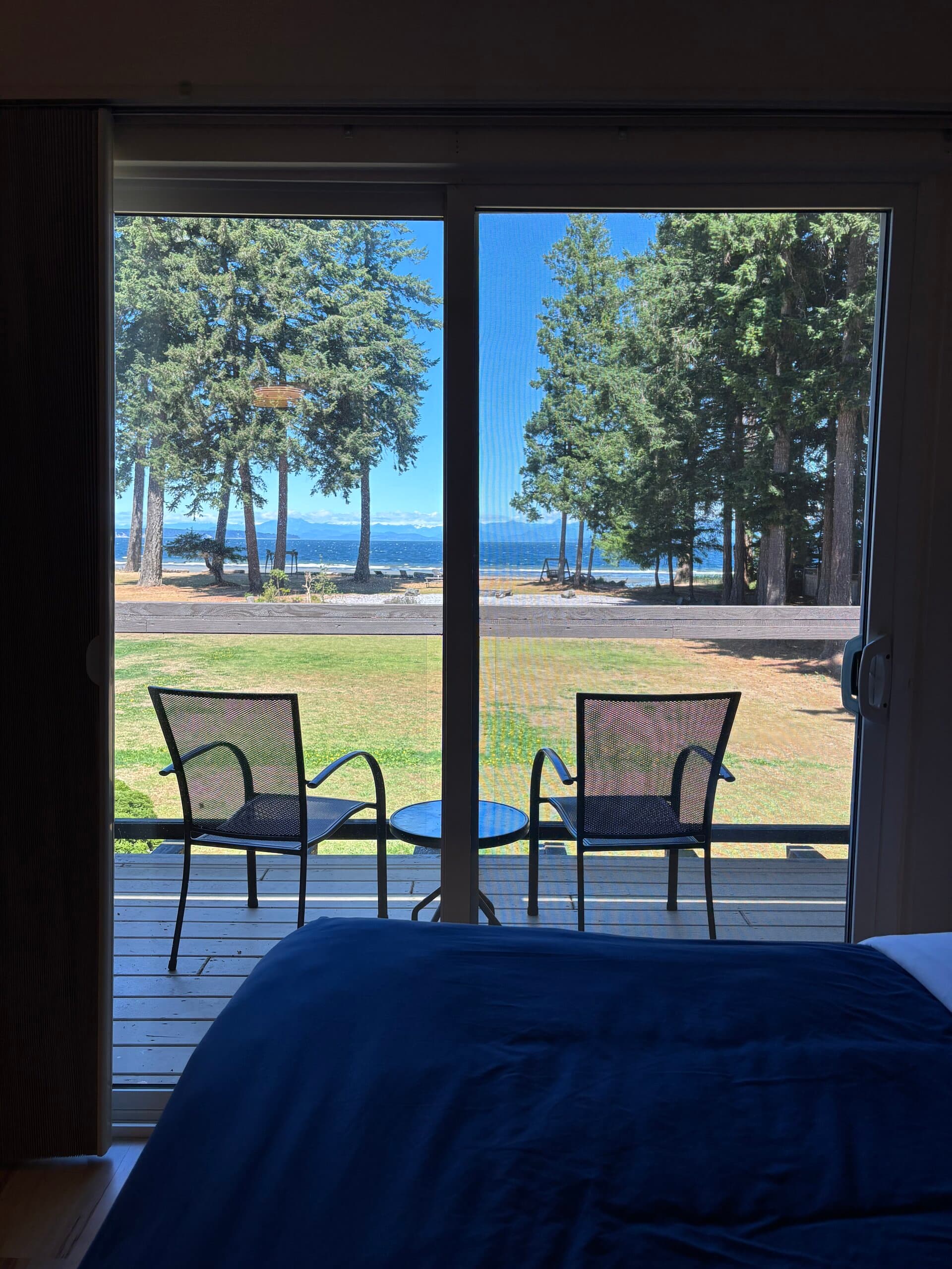 Ocean and mountain views from the beds through balcony doors