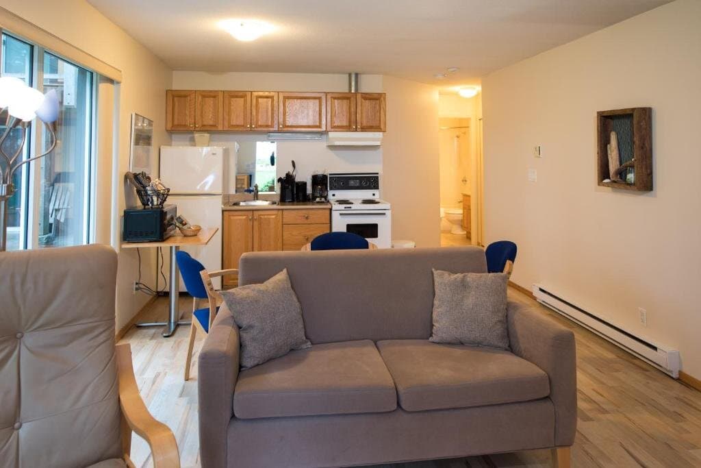 One-bedroom suite open living area with full kitchen and sofa