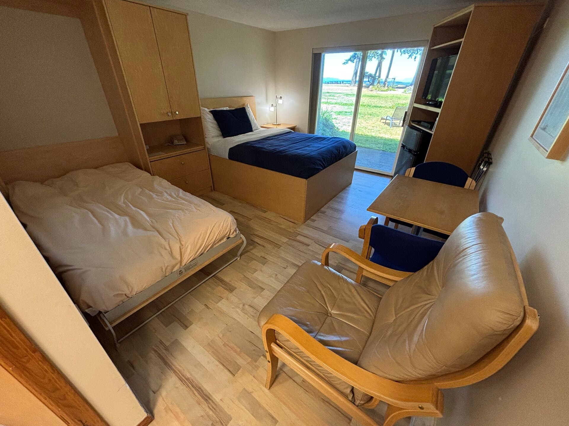 Murphy bed and queen bed with Pacific views through sliding doors