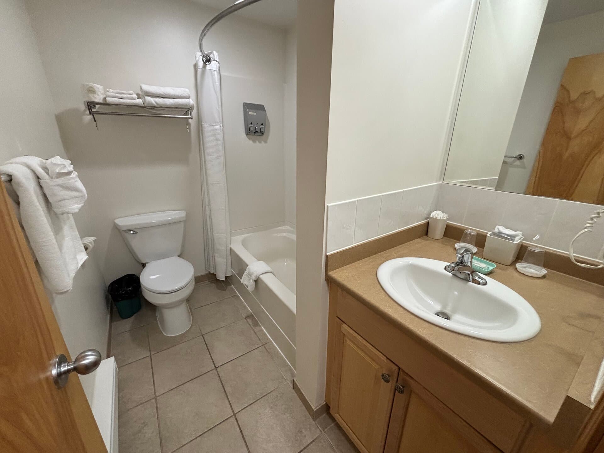 Private bathroom with vanity, tub, and shower combination