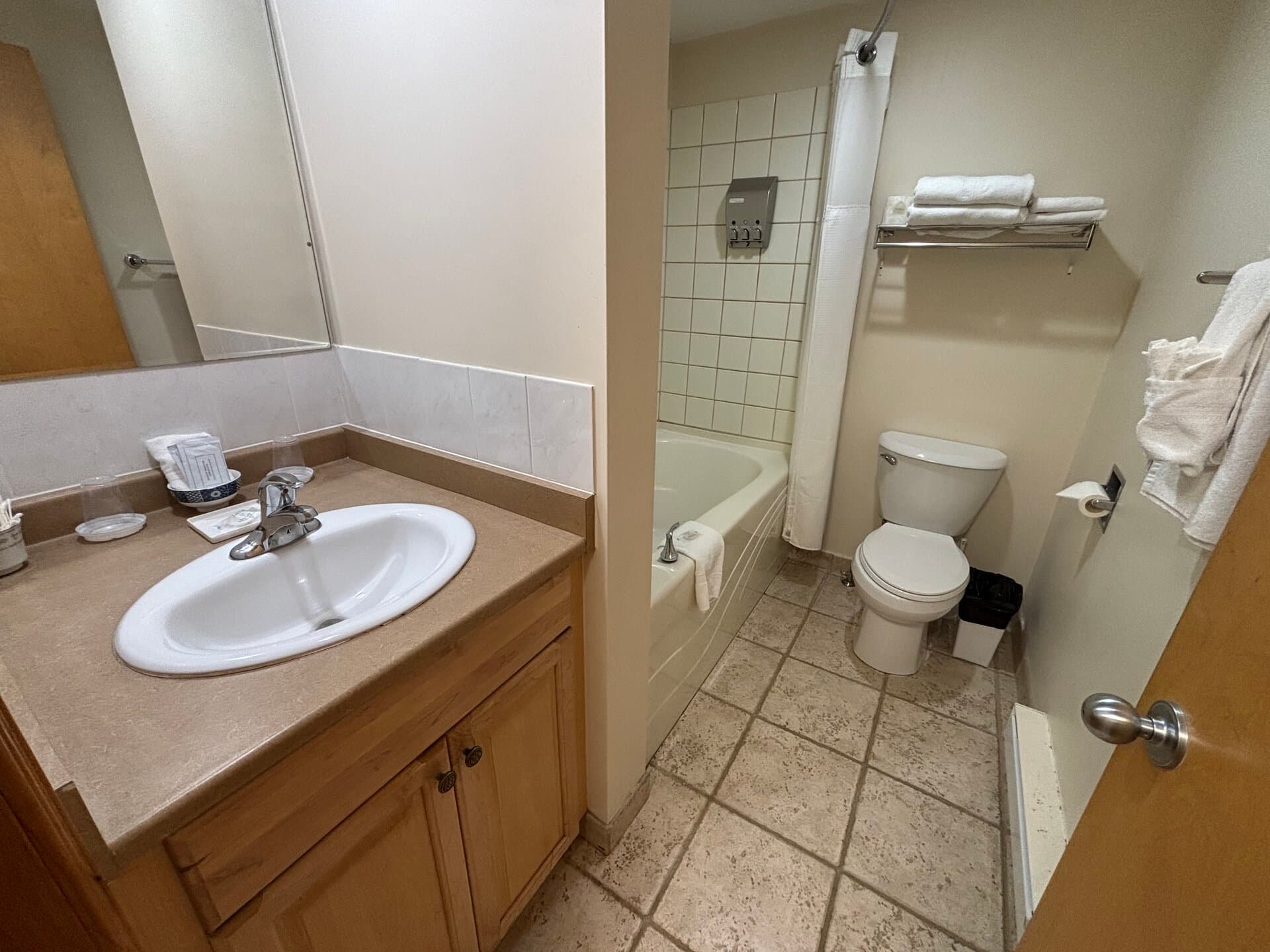 Private bathroom with vanity, tub, and shower combination