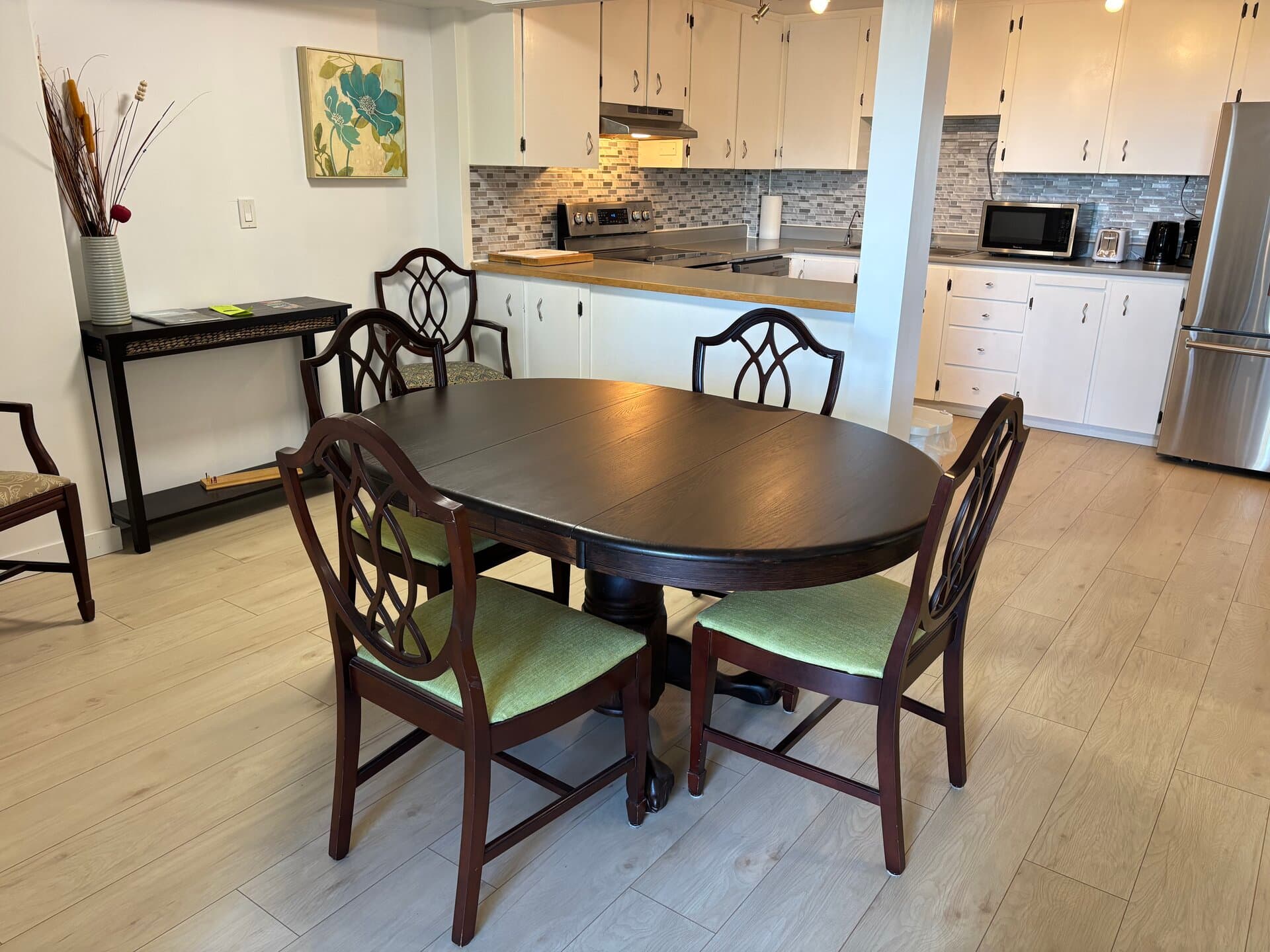Dining table for four beside the suite's full kitchen