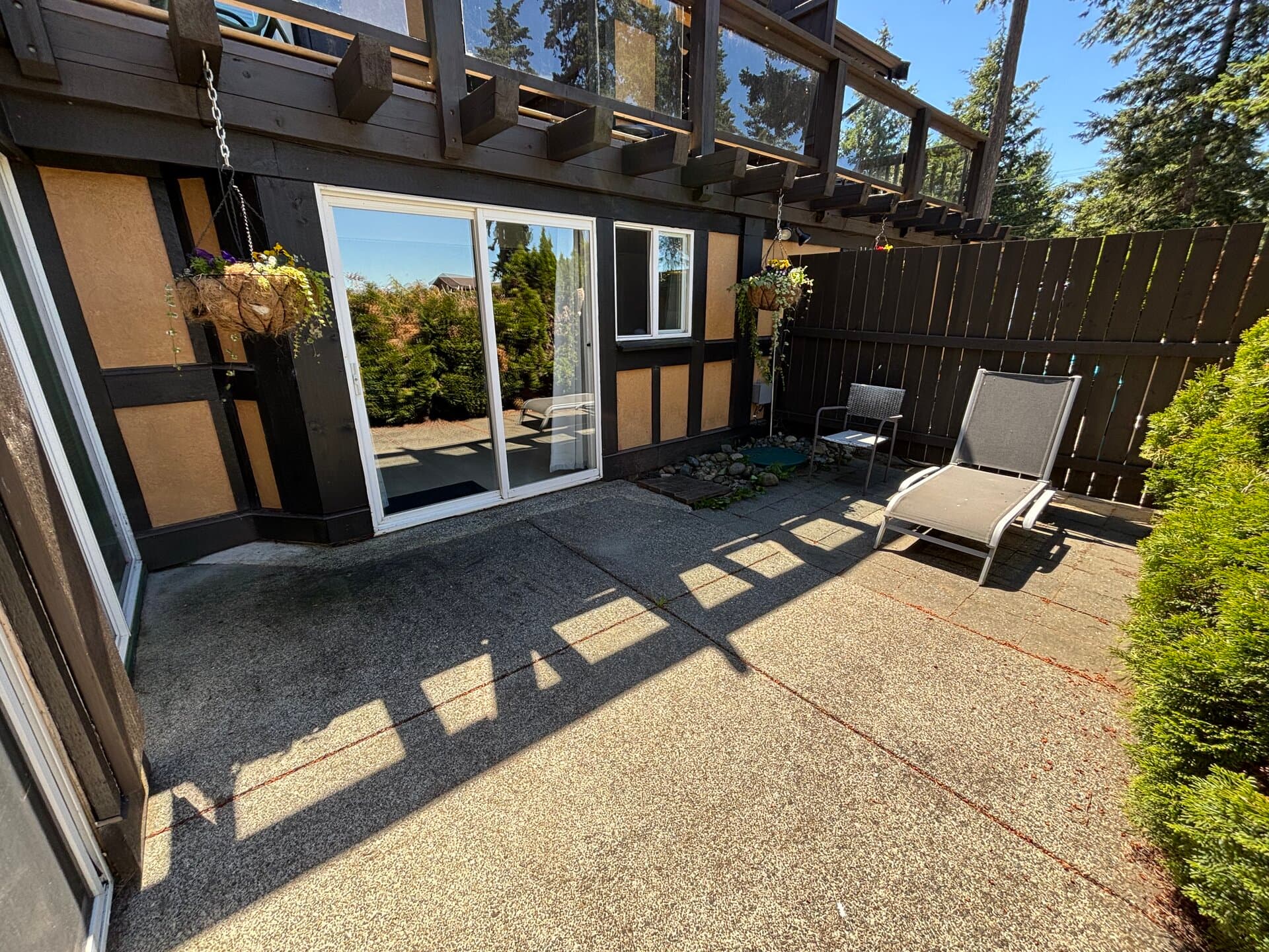 Spacious private patio with seating and sliding-door suite access