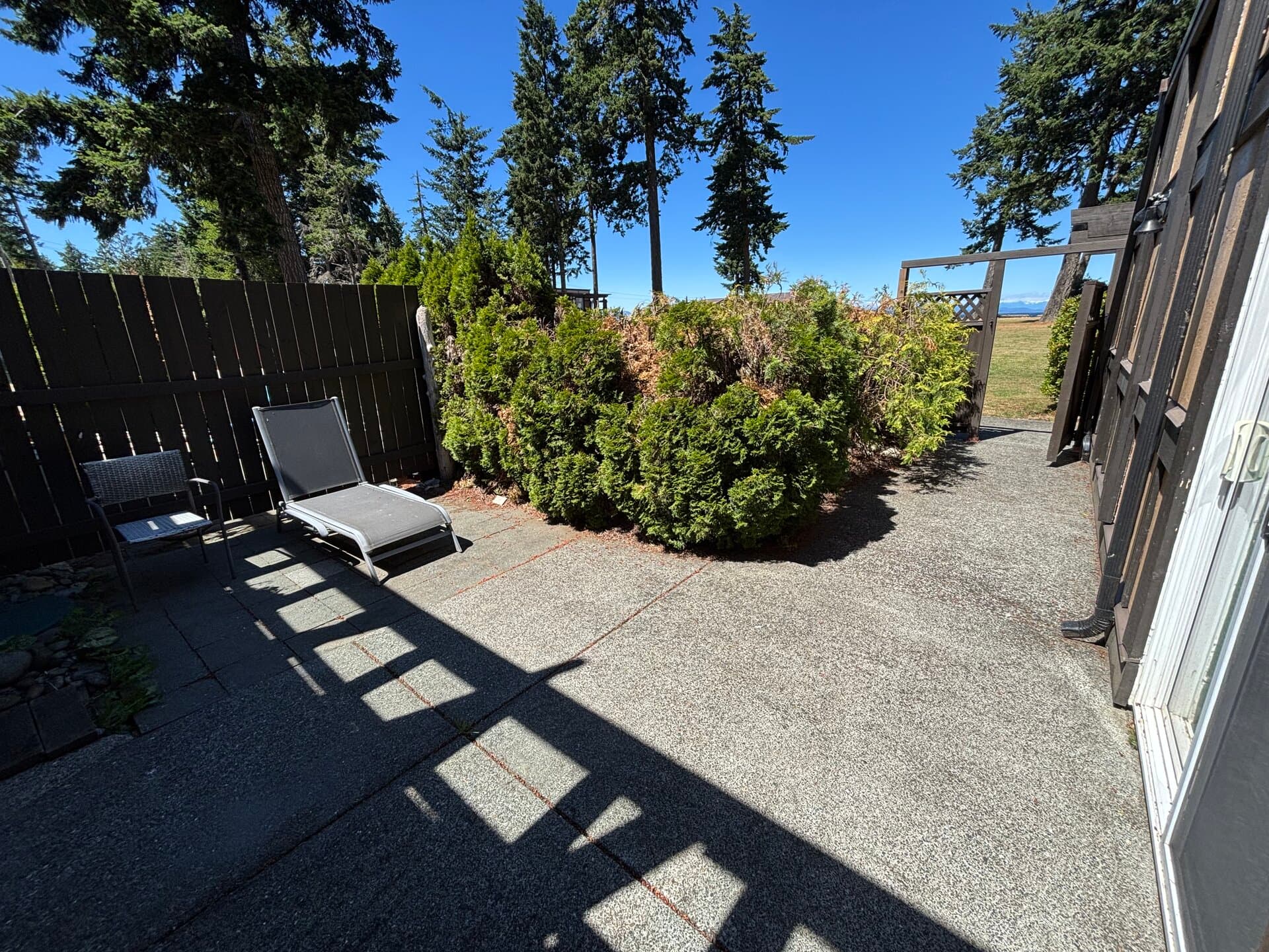 Private garden patio with a lounge chair and outdoor seating
