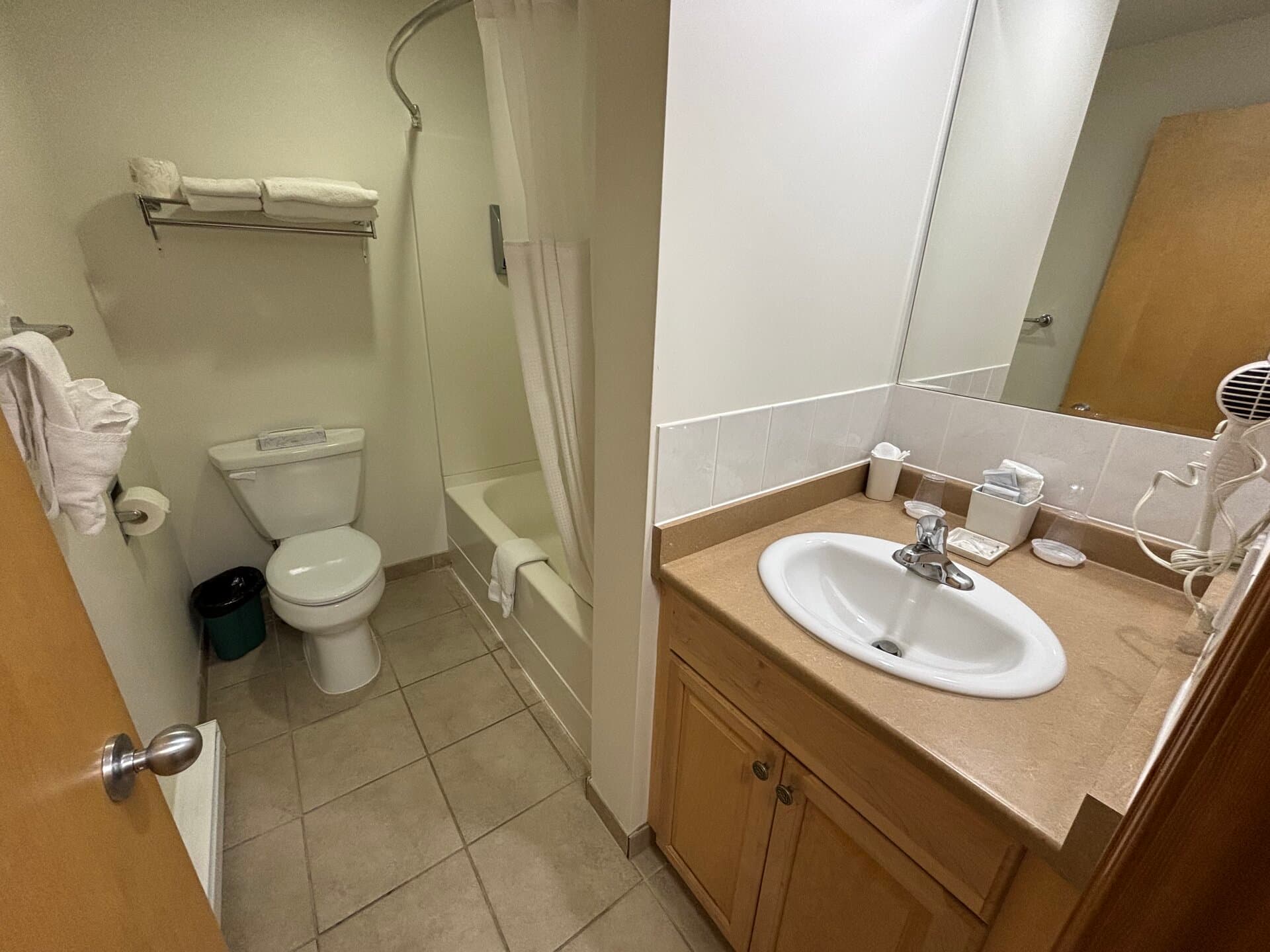 Private bathroom with vanity, tub, and shower combination