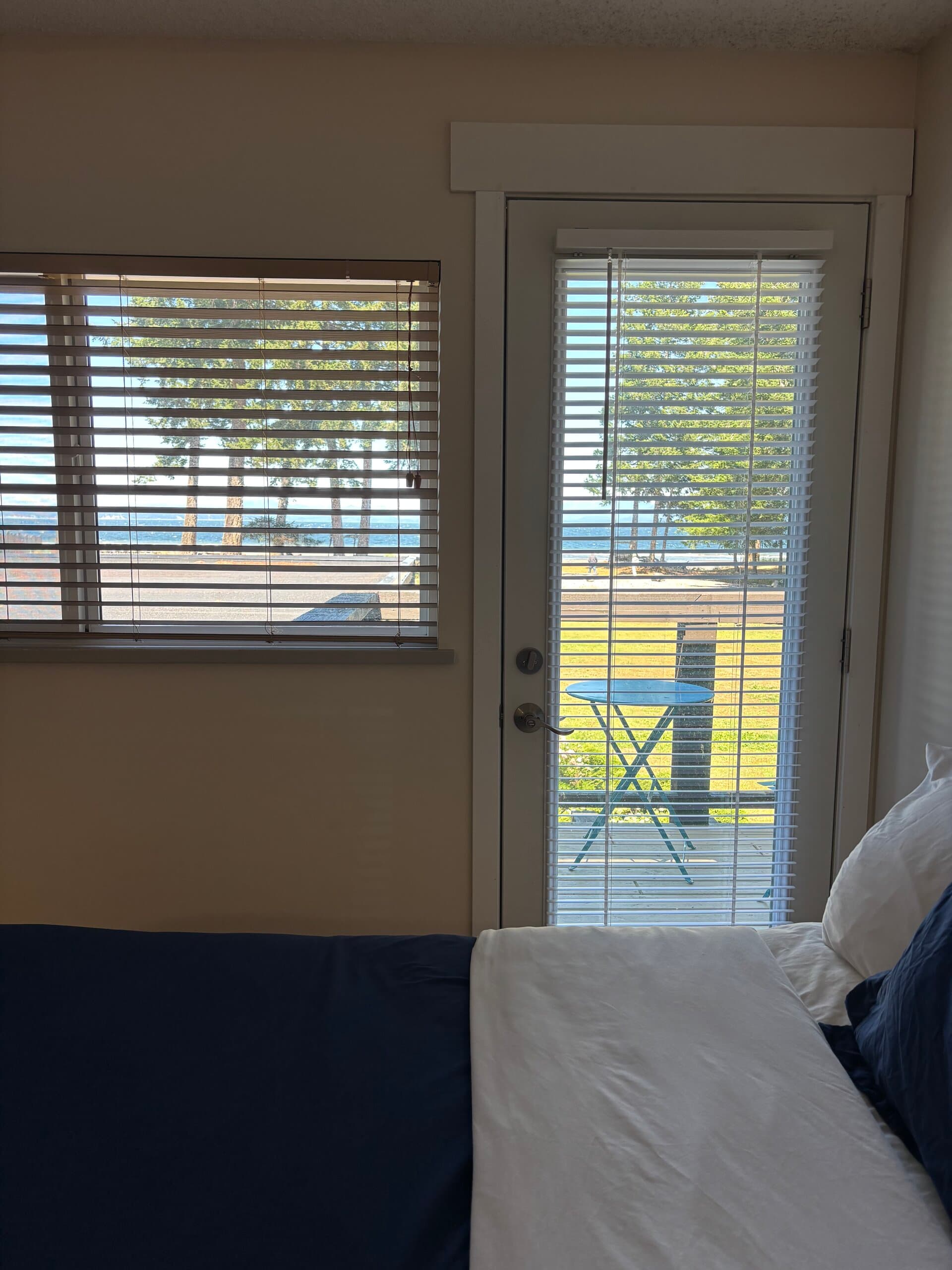 Ocean and lawn views from the double bed through the balcony door