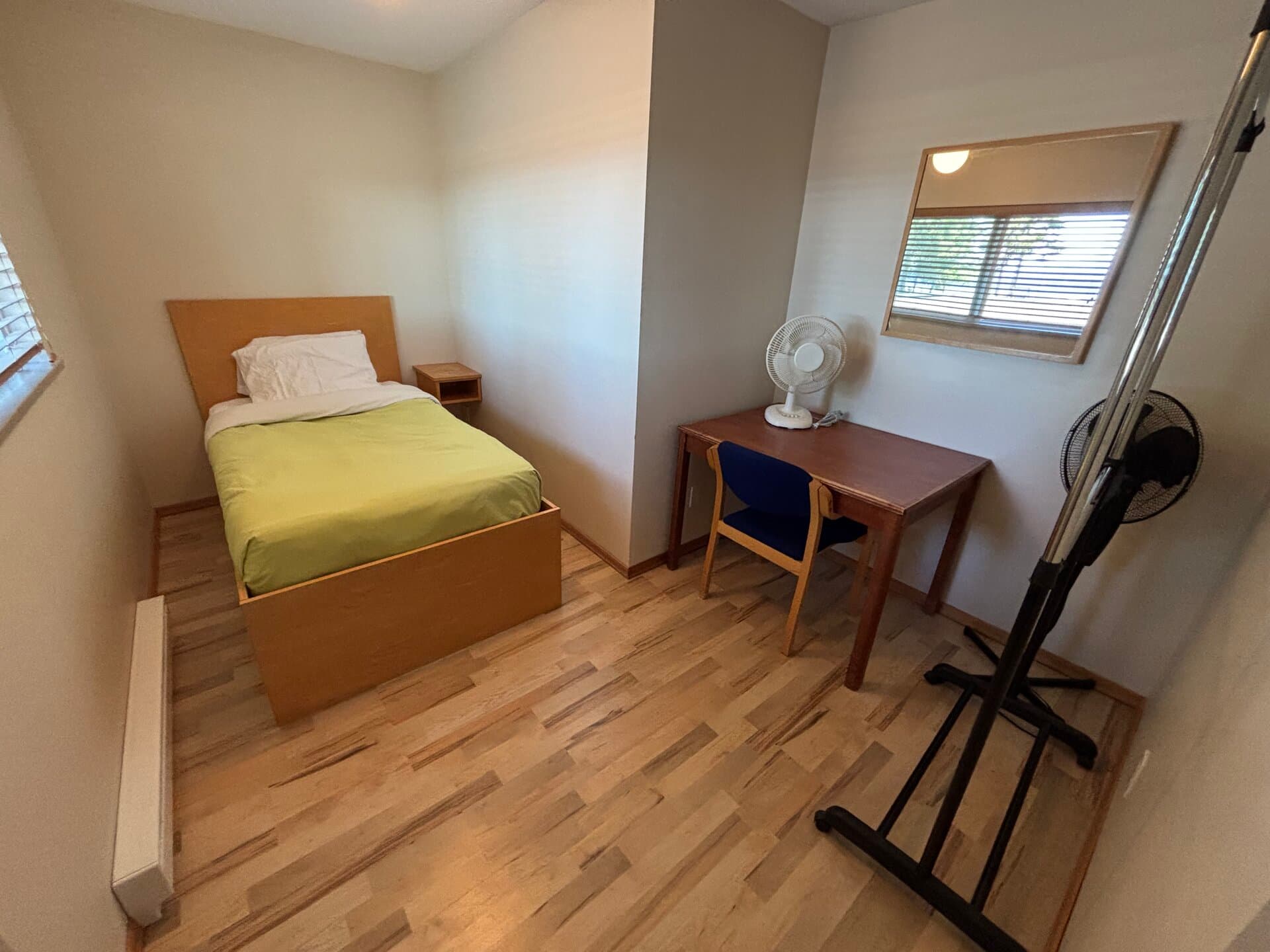 Adjoining room with single bed, desk, mirror, and fan