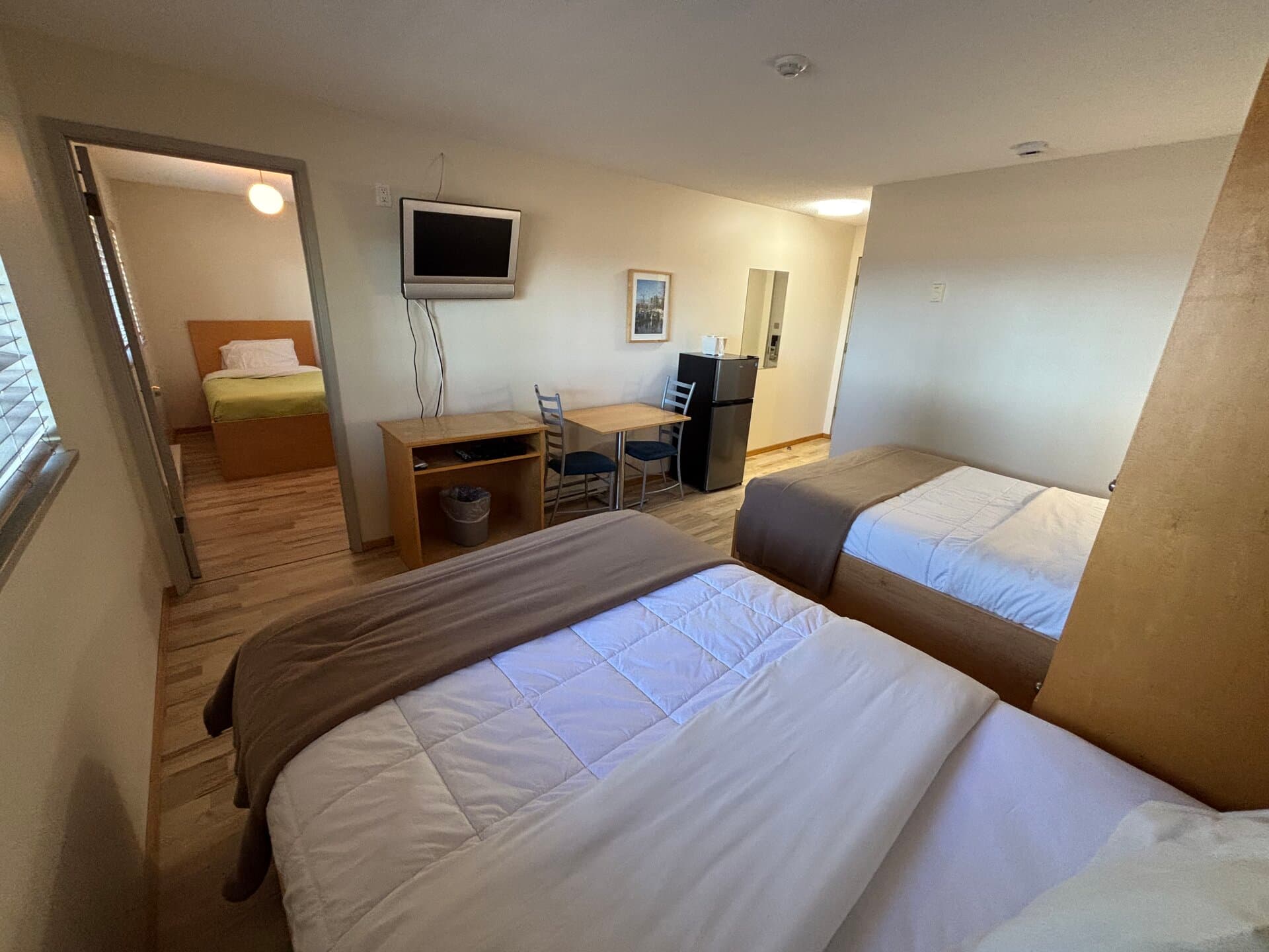 Two double beds with adjoining single-bed room — ideal for families