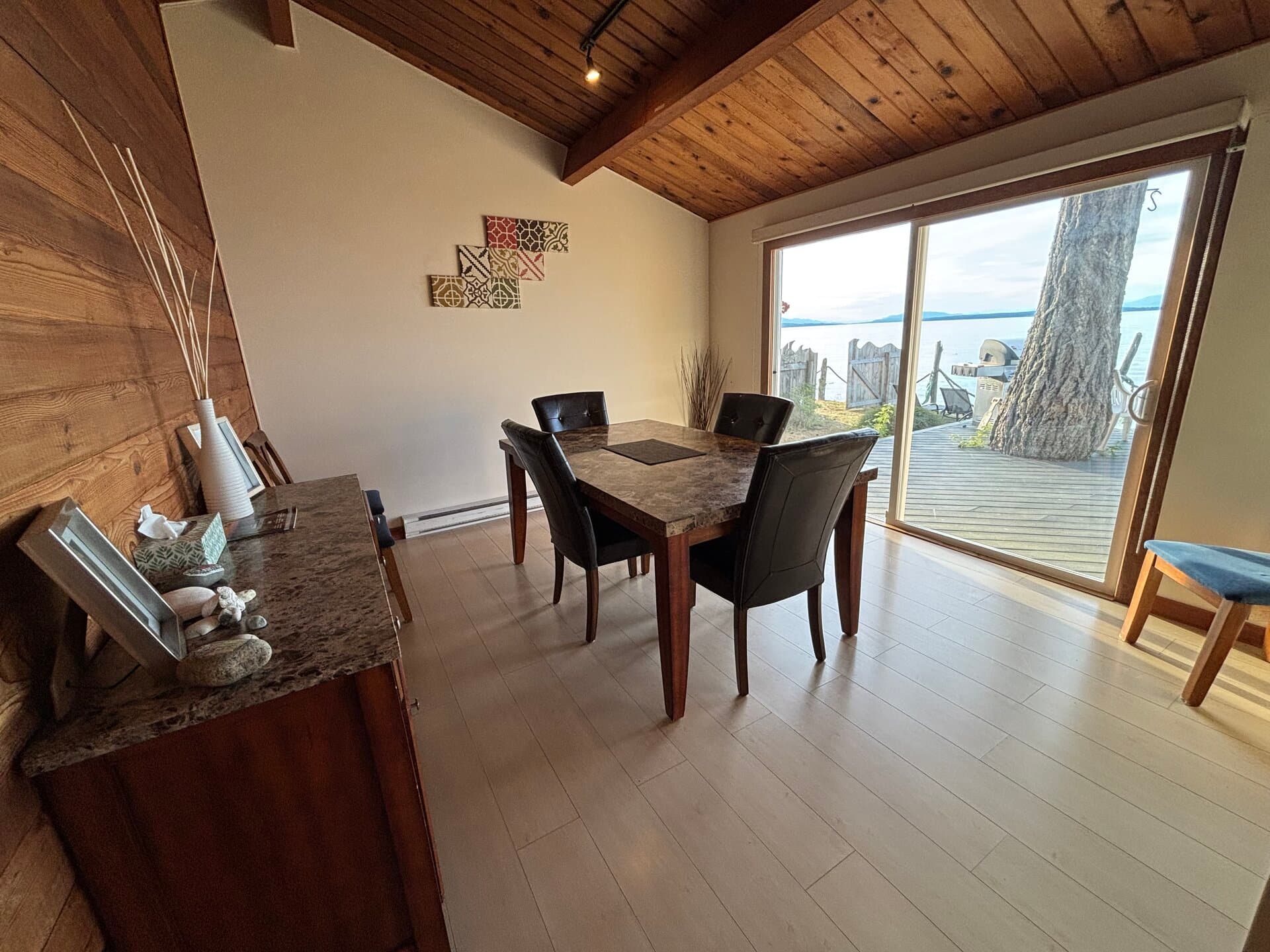Dining room with vaulted wood ceiling and ocean views