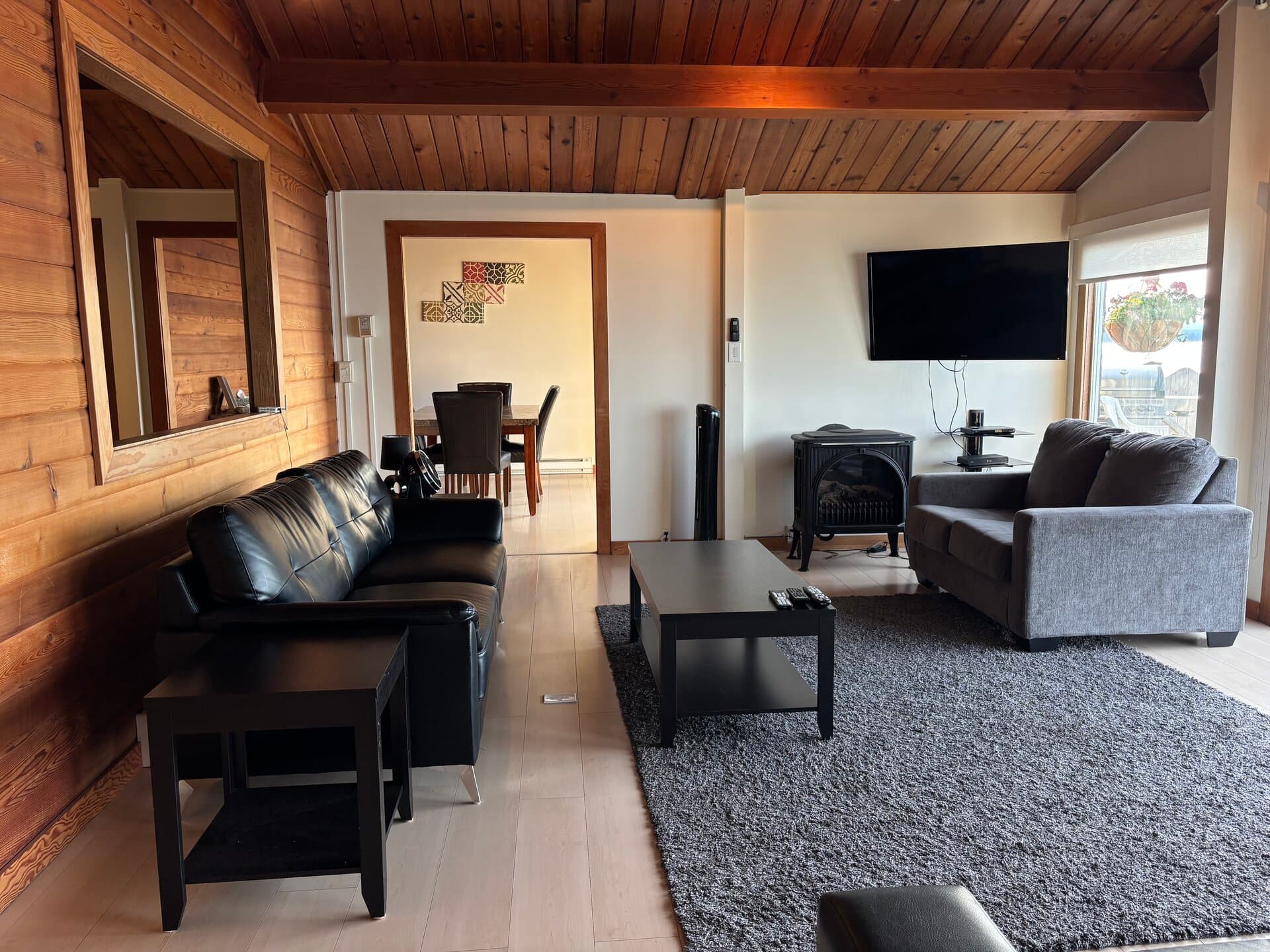 Living and dining area with fireplace and vaulted ceiling