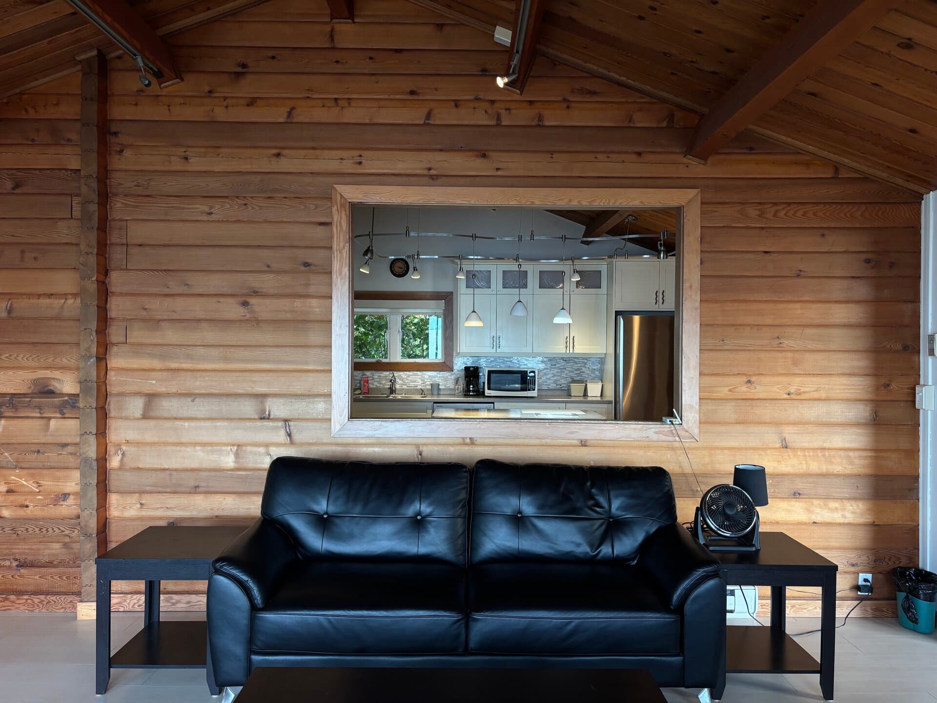 Living room with kitchen pass-through and log walls