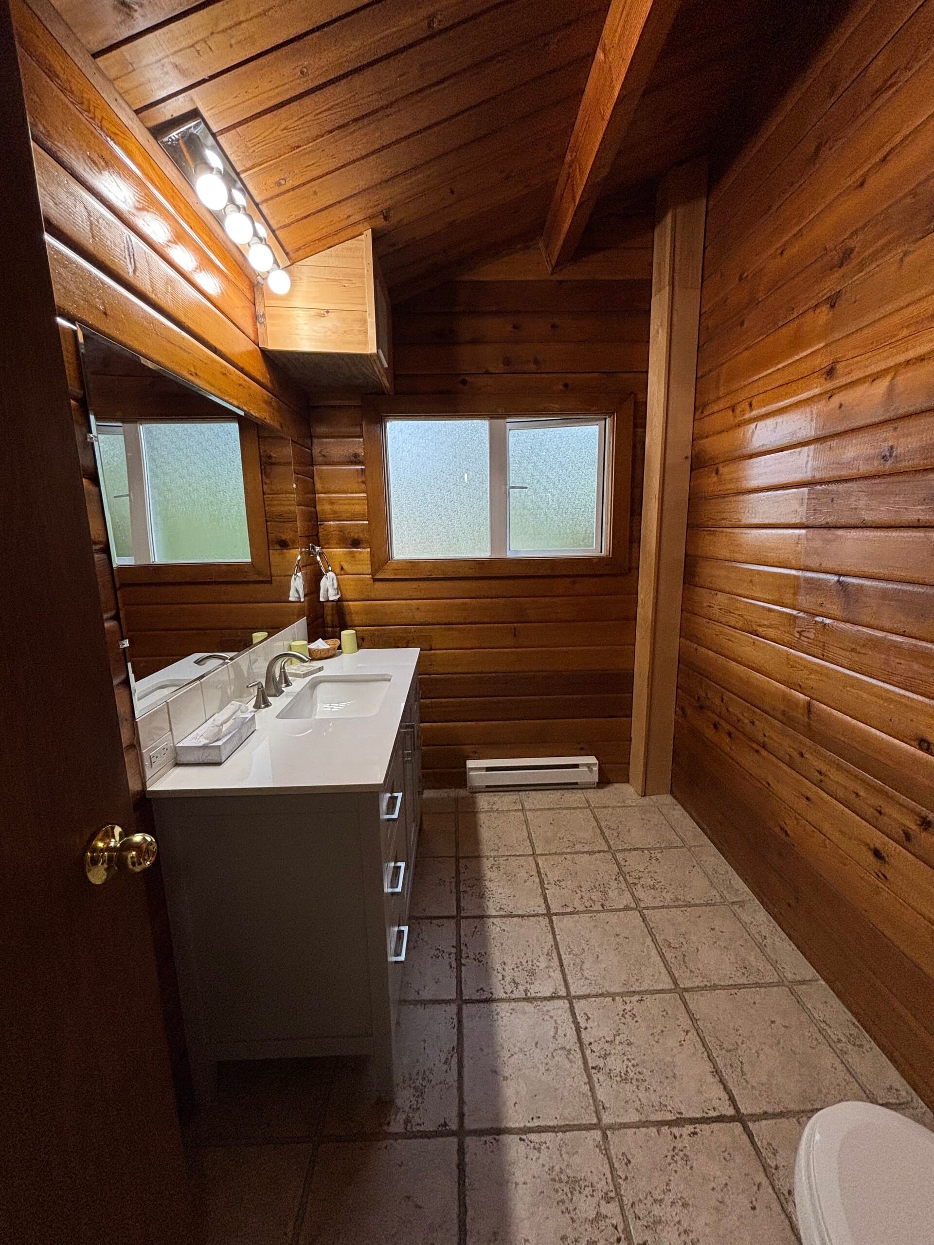 Rustic wood-paneled bathroom vanity