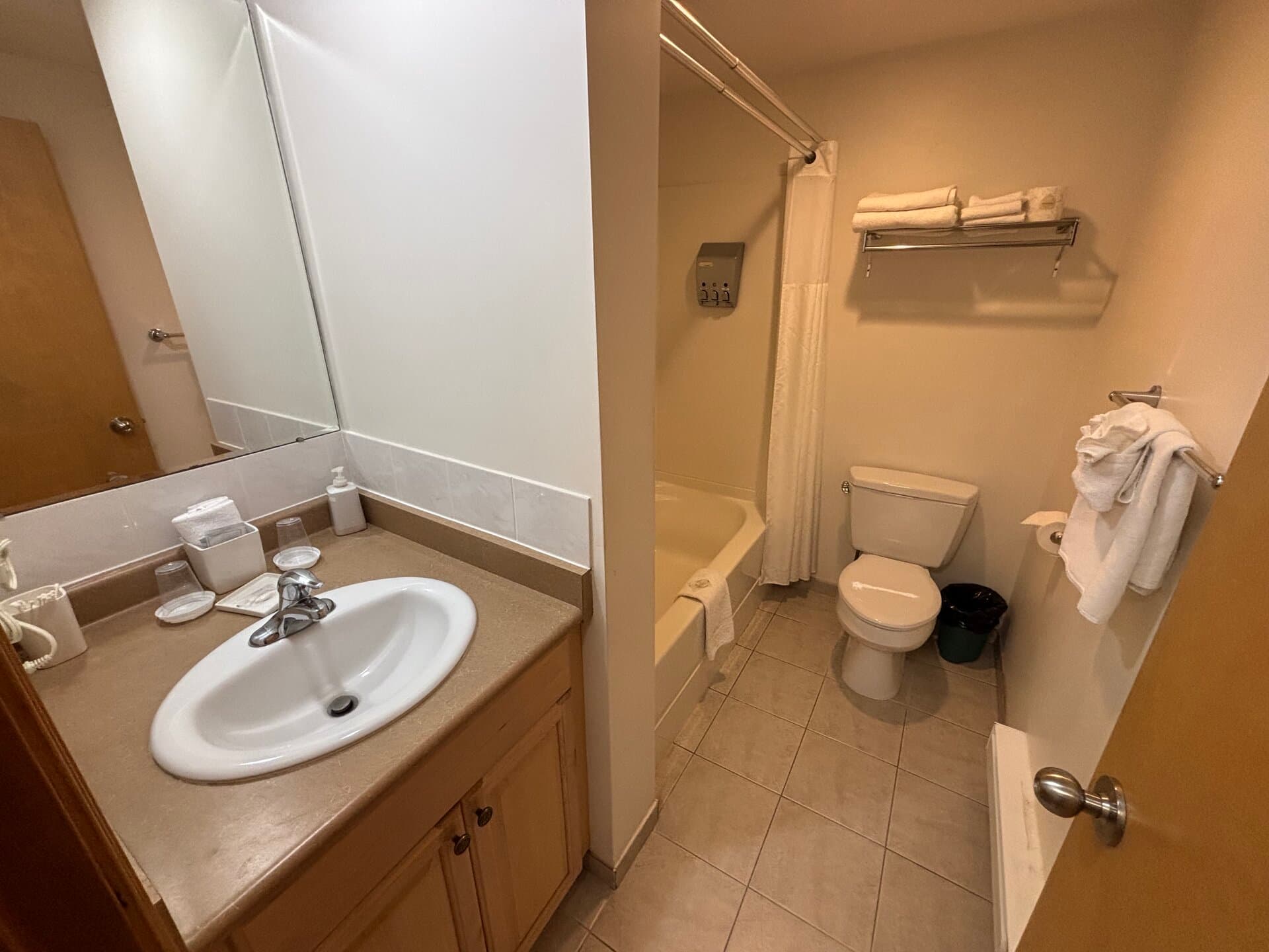 Private bathroom with vanity, tub, and shower combination