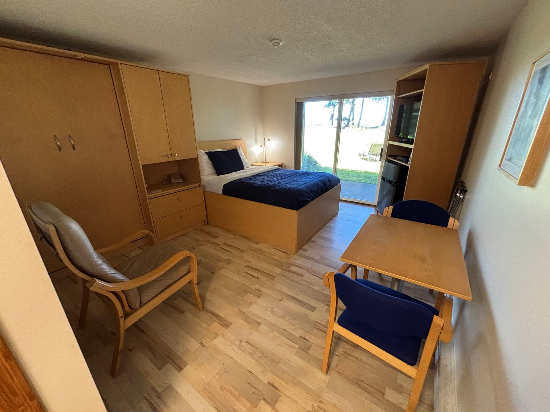 Queen bed and Murphy cabinet with sliding door to ocean-view patio