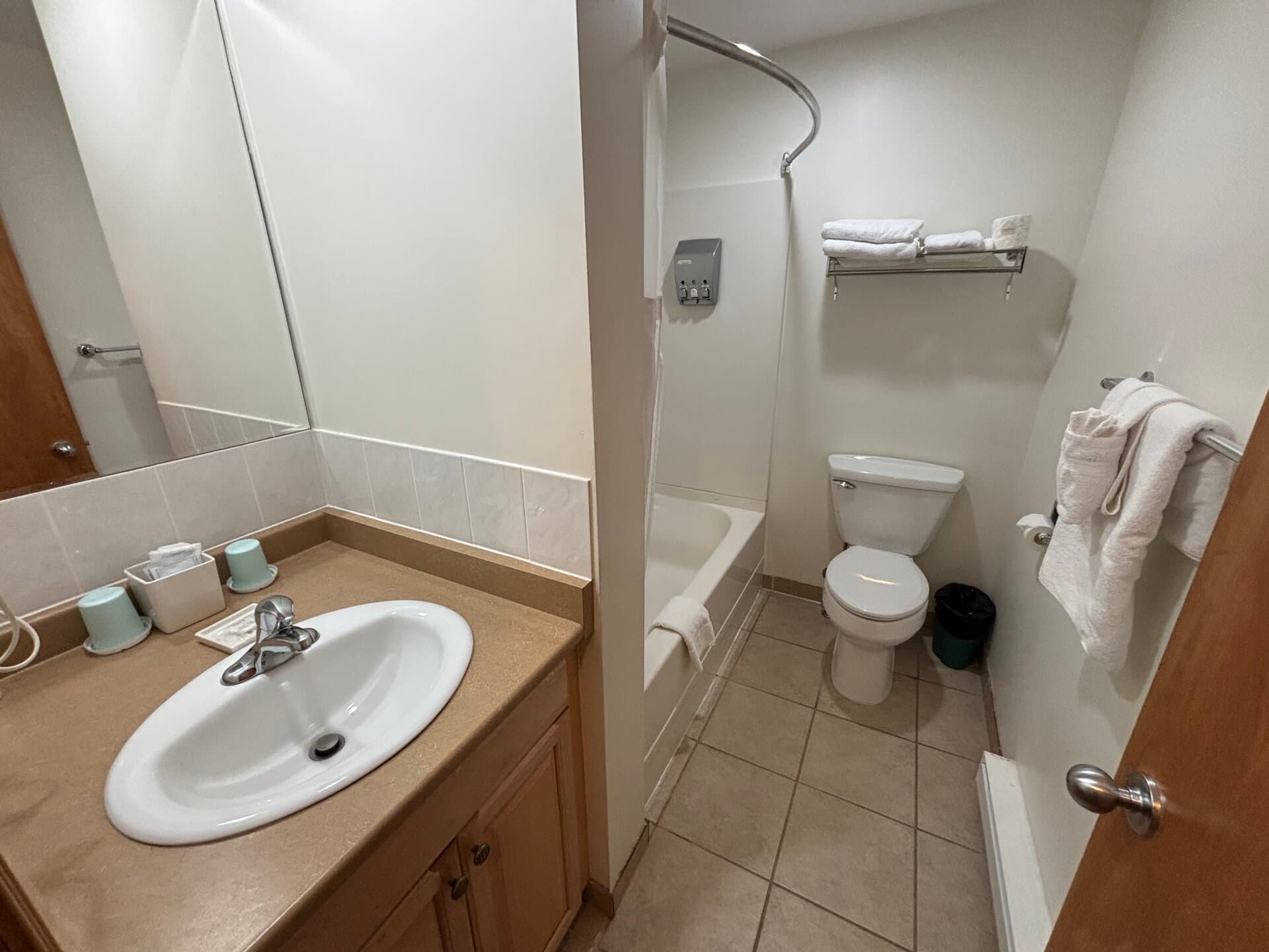 Private bathroom with vanity, tub, and shower combination