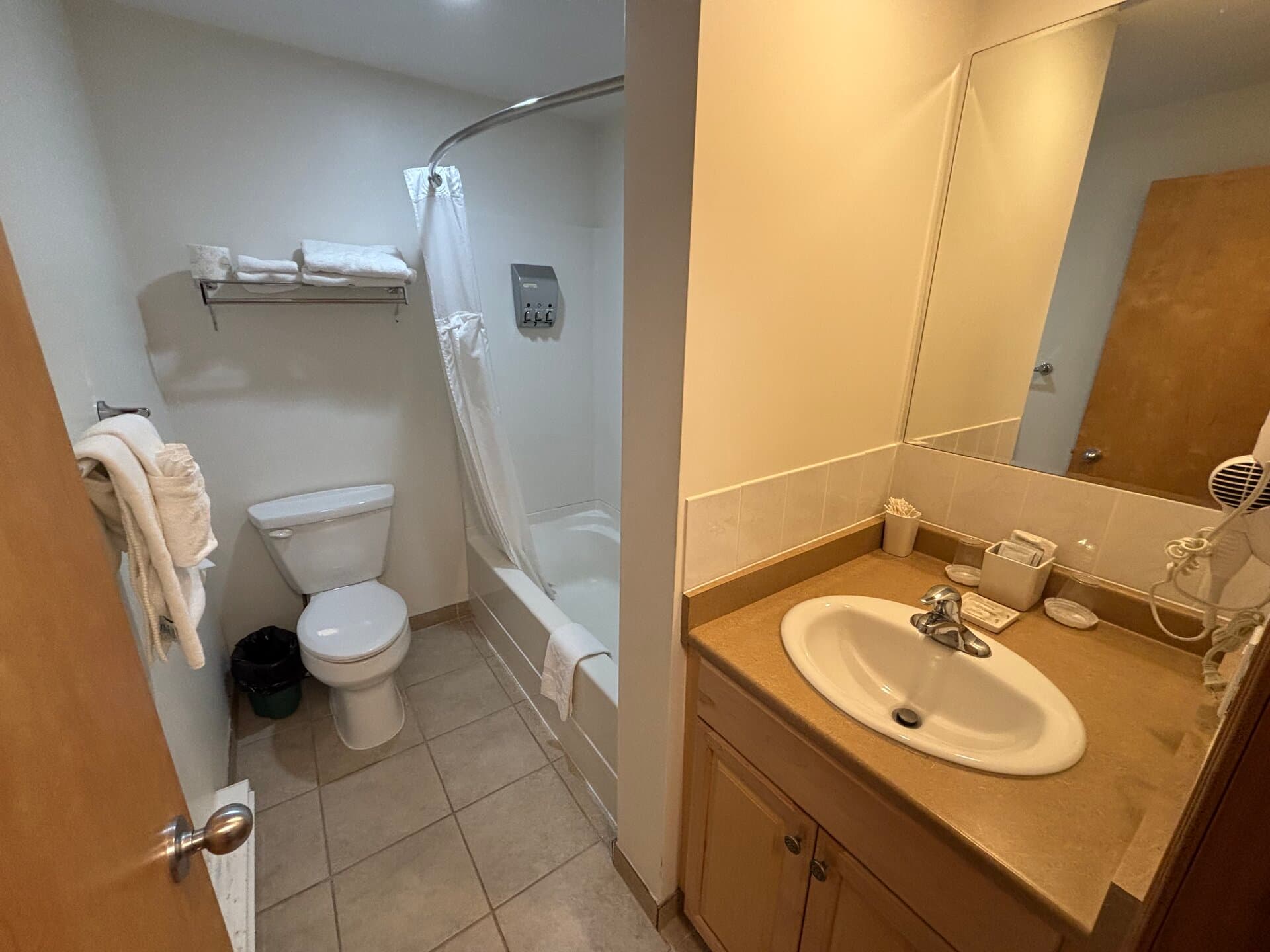 Private bathroom with vanity, tub, and shower combination