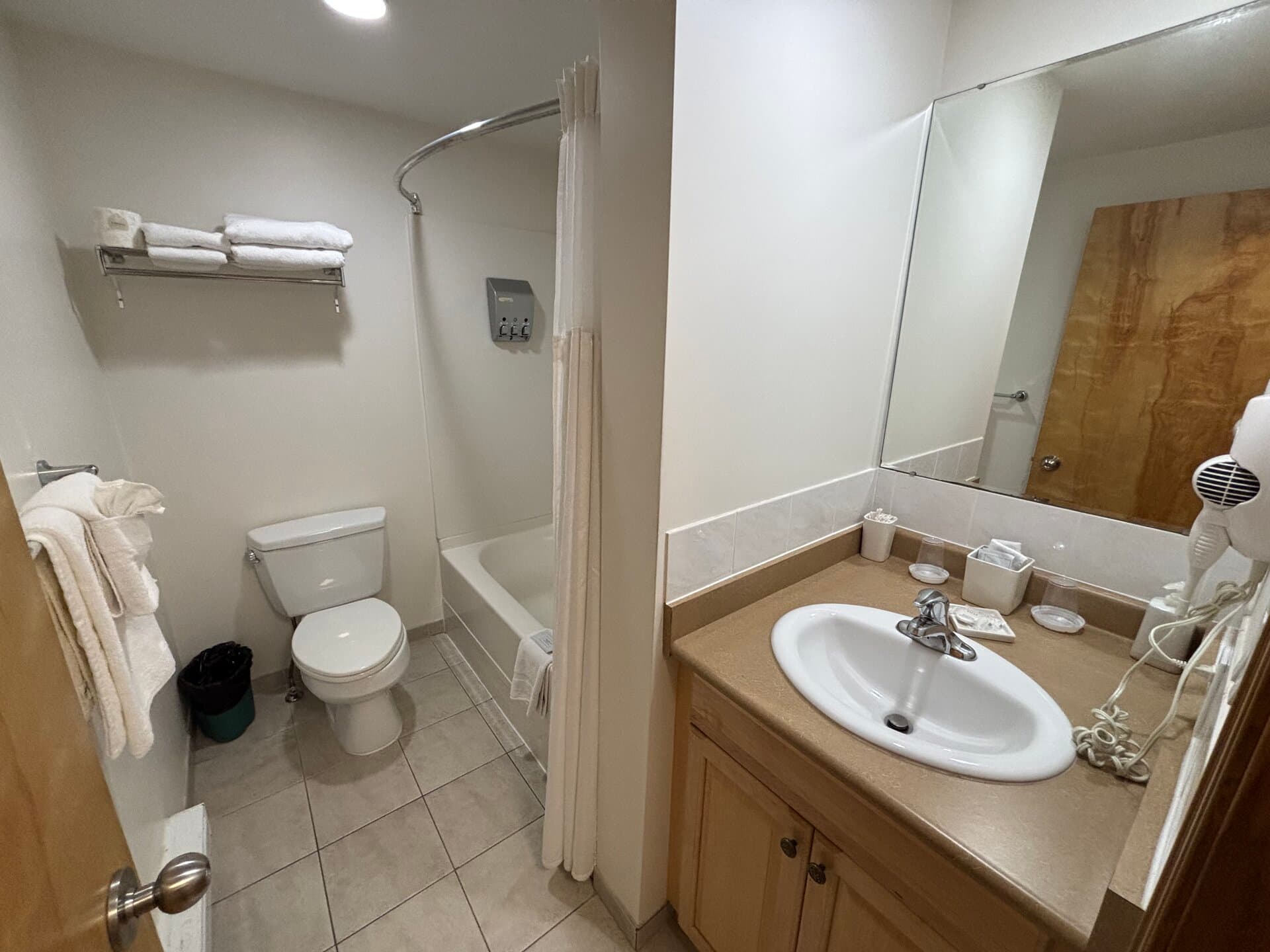 Private bathroom with vanity, tub, and shower combination
