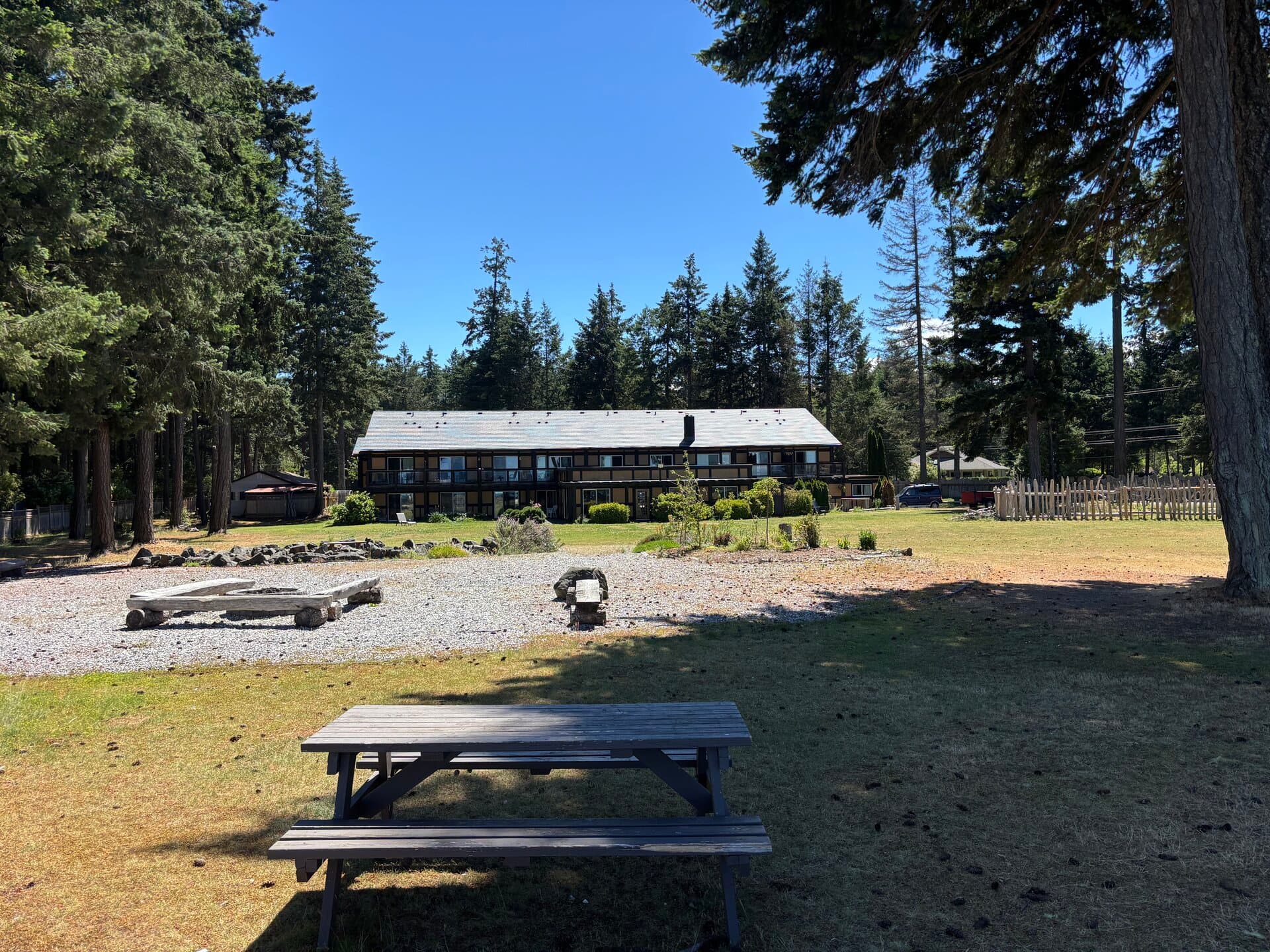 Resort grounds with picnic table, fire pit, and lodge